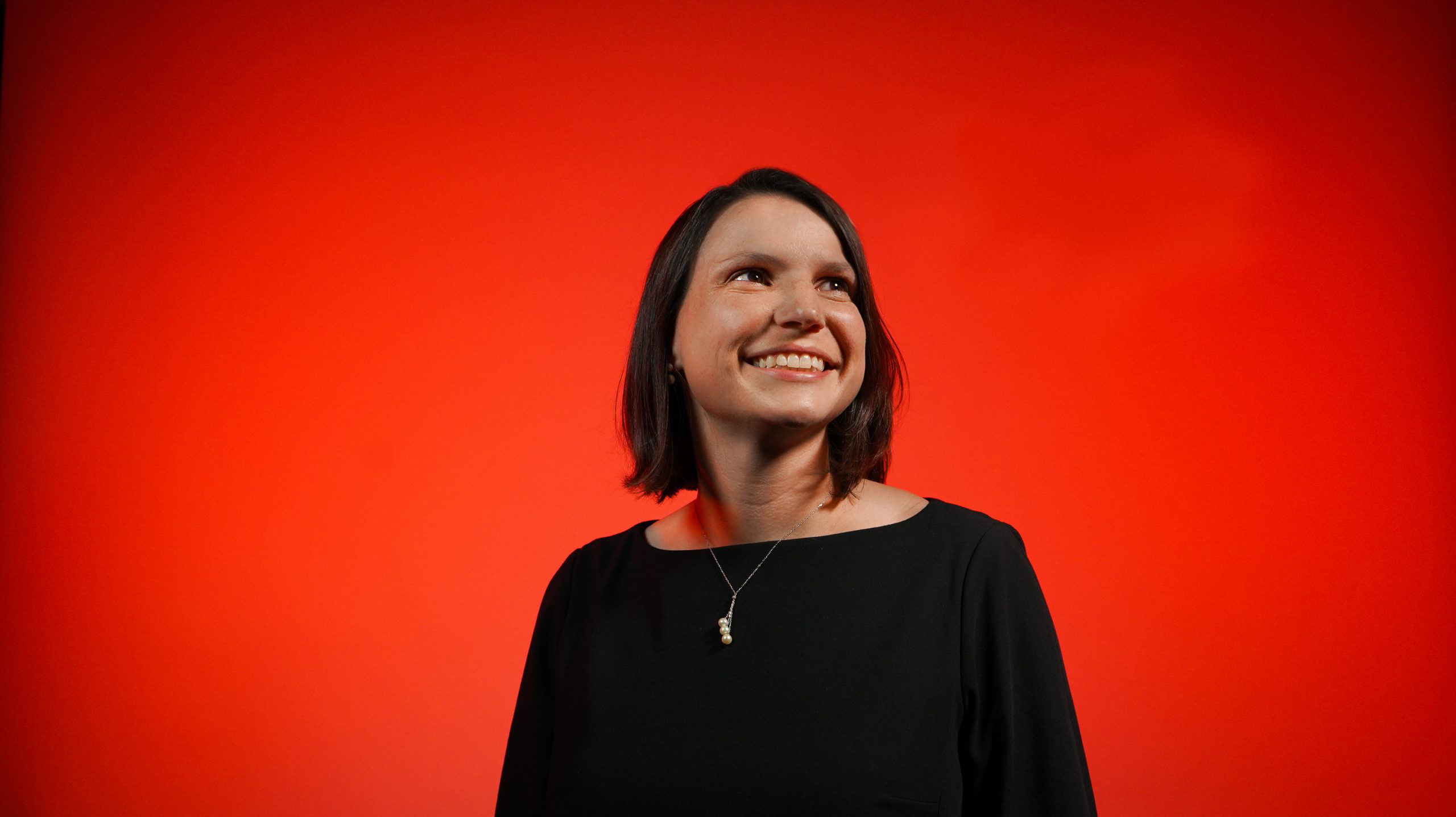 woman looking up on red background