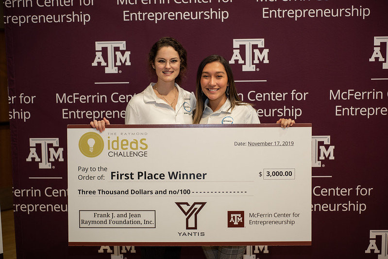 Armstrong and Young holding a large check at the 2019 Raymond Ideas Challenge where they won 1st place and $3,000