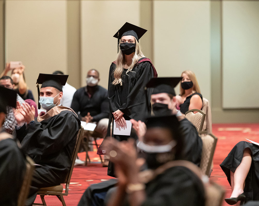 Woman in graduation cap and mask