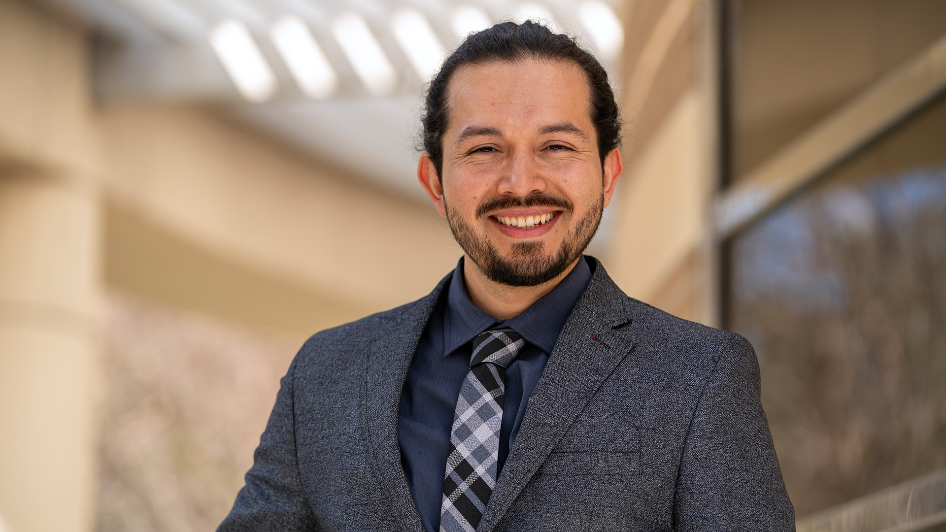 Andres Jola-Sanchez standing outside and smiling