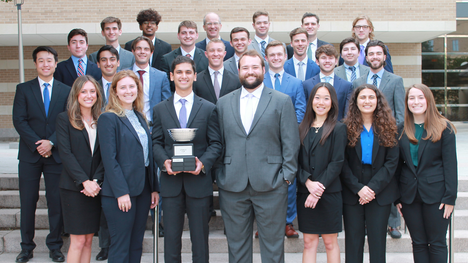 Group of Investment Management students holding a trophy