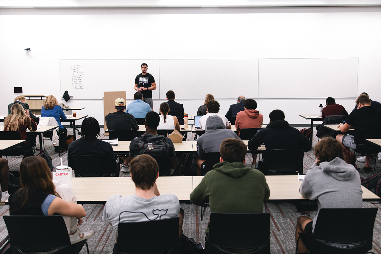 Group of students listening to another student who is presenting