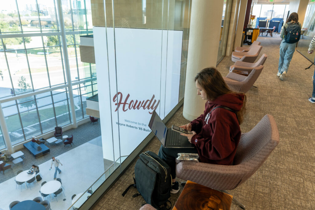 Student sitting in a chair looking at her laptop