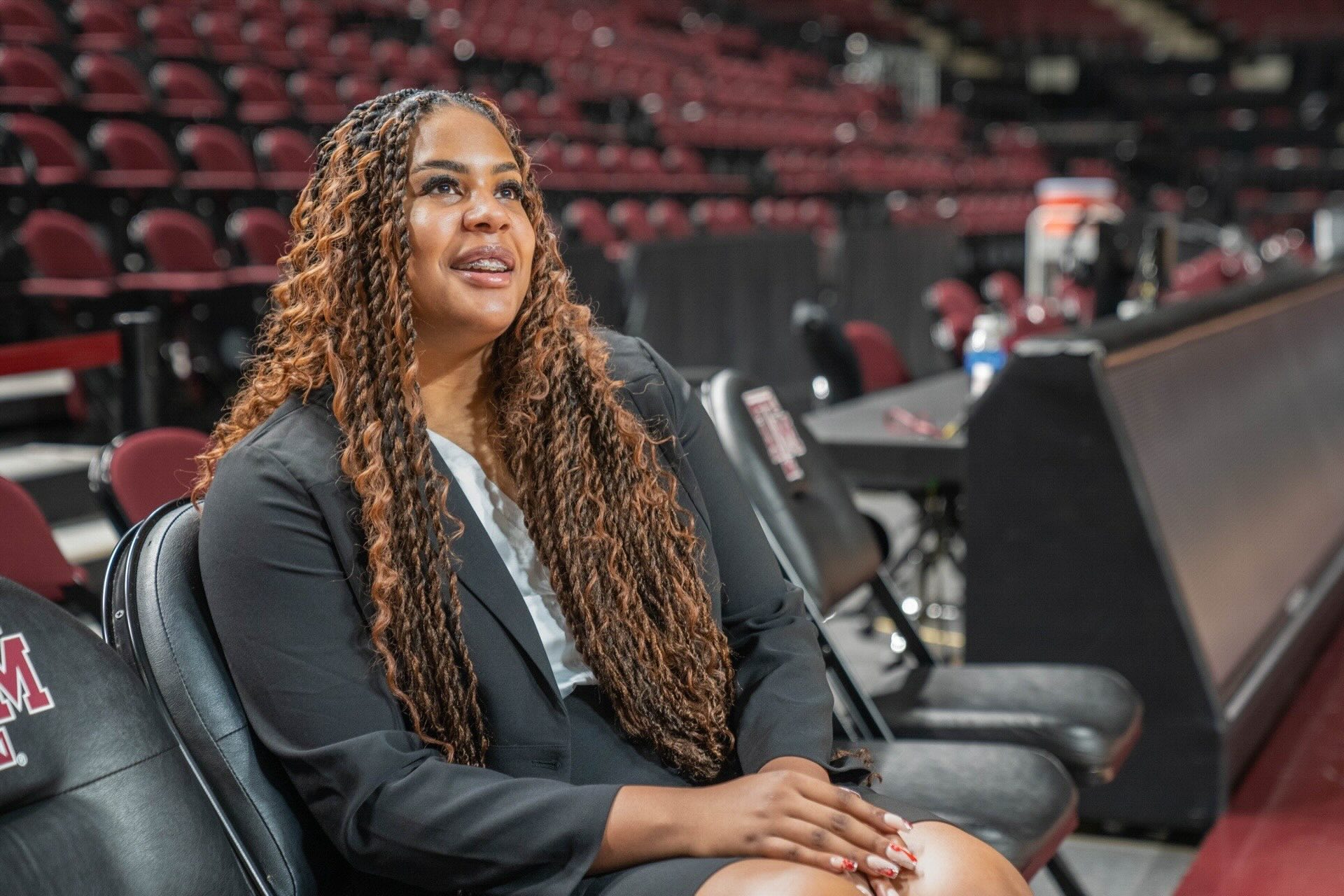 Jada Malone sitting on a chair in the basketball court