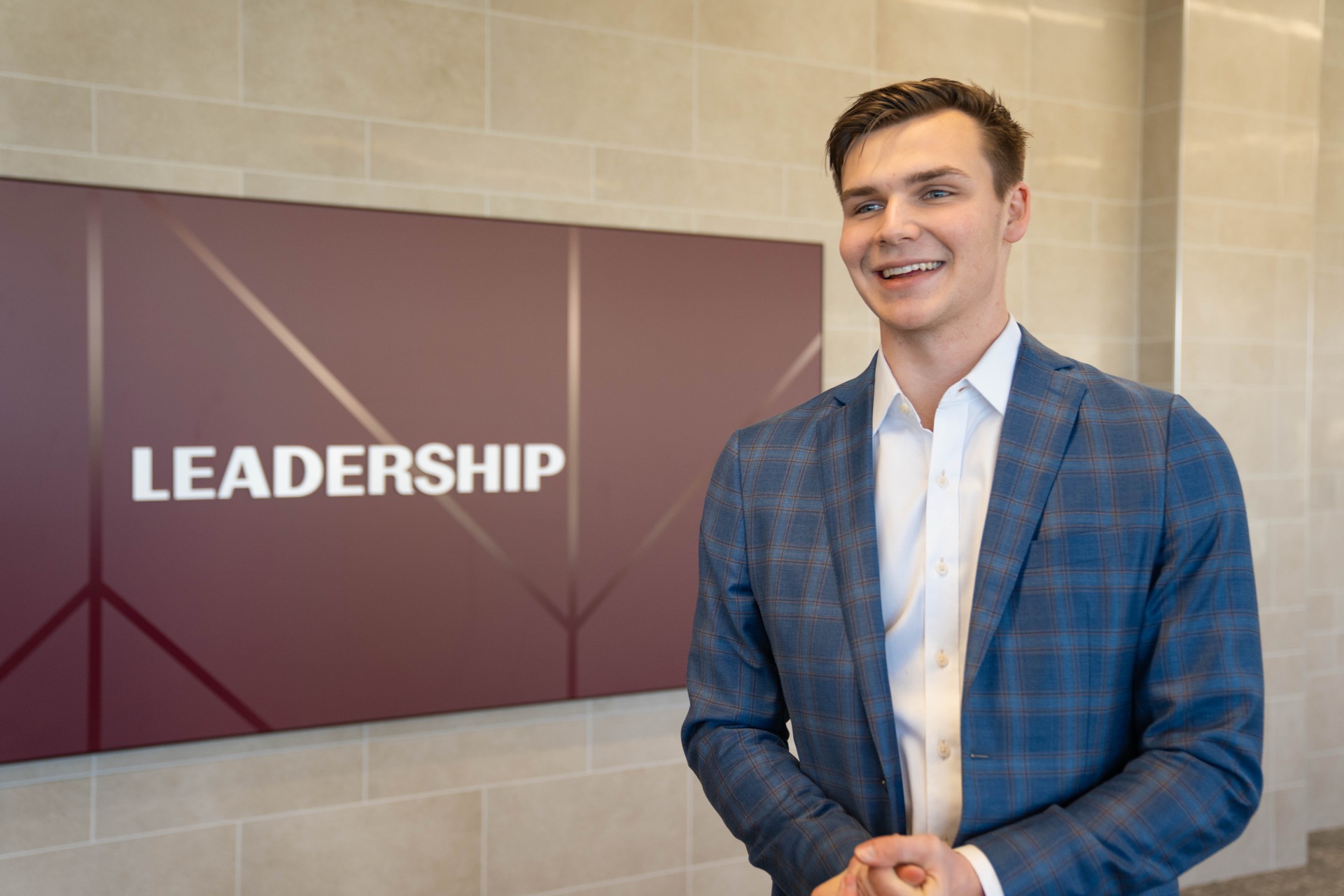 Cade Coppinger talking in front of the leadership sign