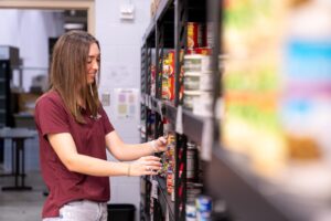 Mazie Johnson at 12th can food pantry stocking canned foods.