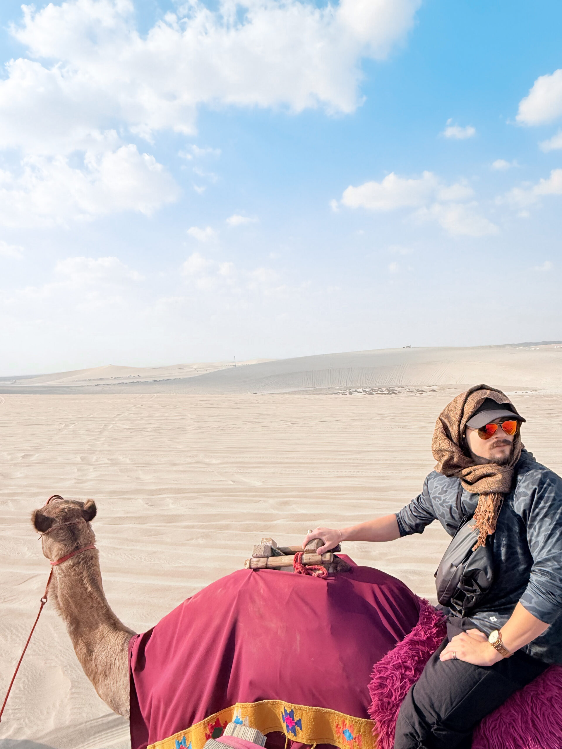 Student riding a camel in Qatar