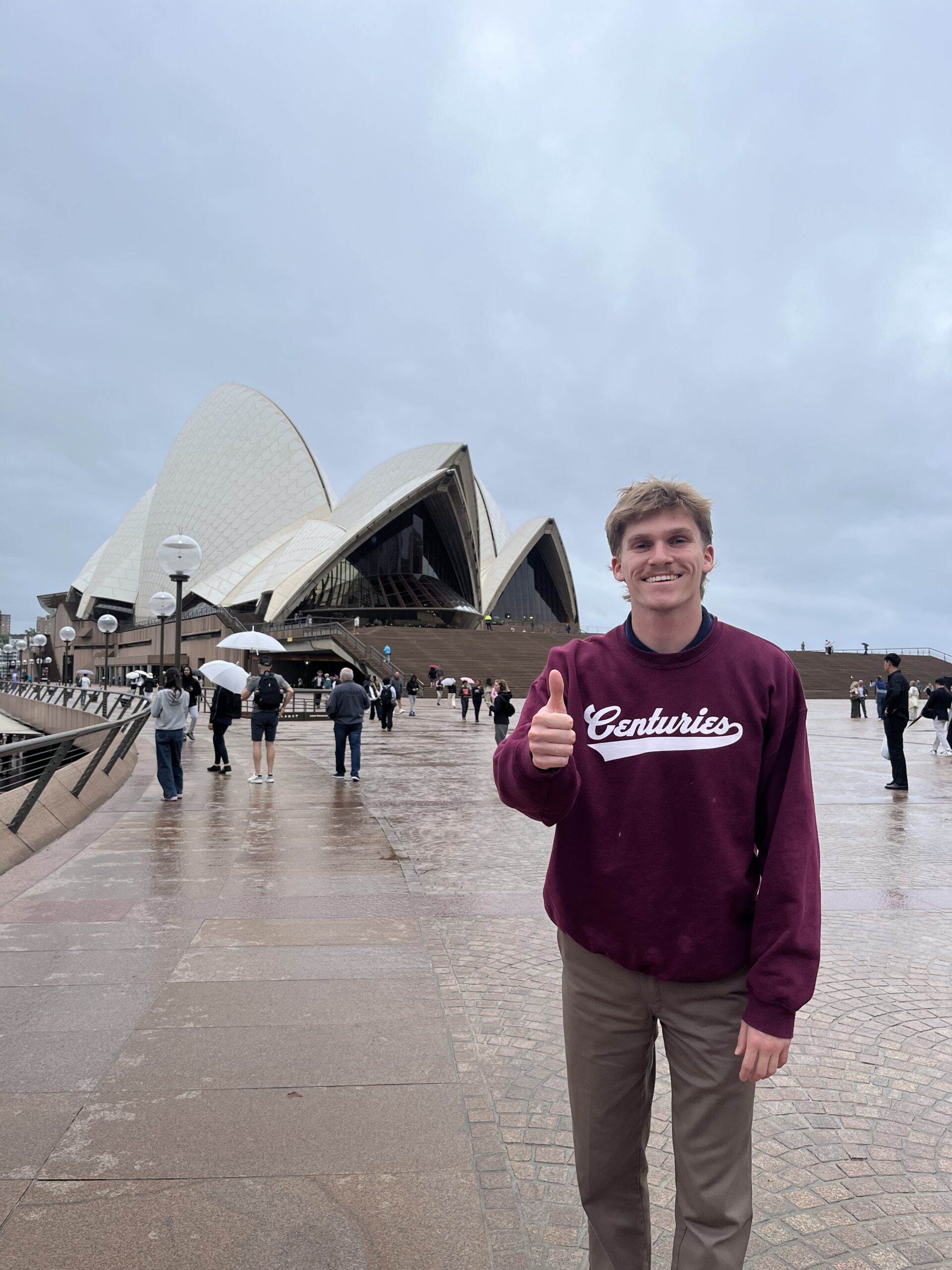 Student Owen Thomas in front of the Sydney Opera House