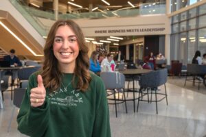 Mazie Johnson in Wayne Roberts building giving thumbs up
