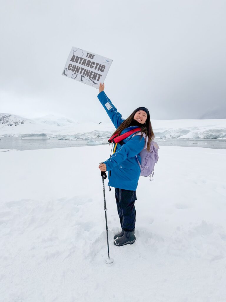 Student Susan Liu holding a banner in Antarctica